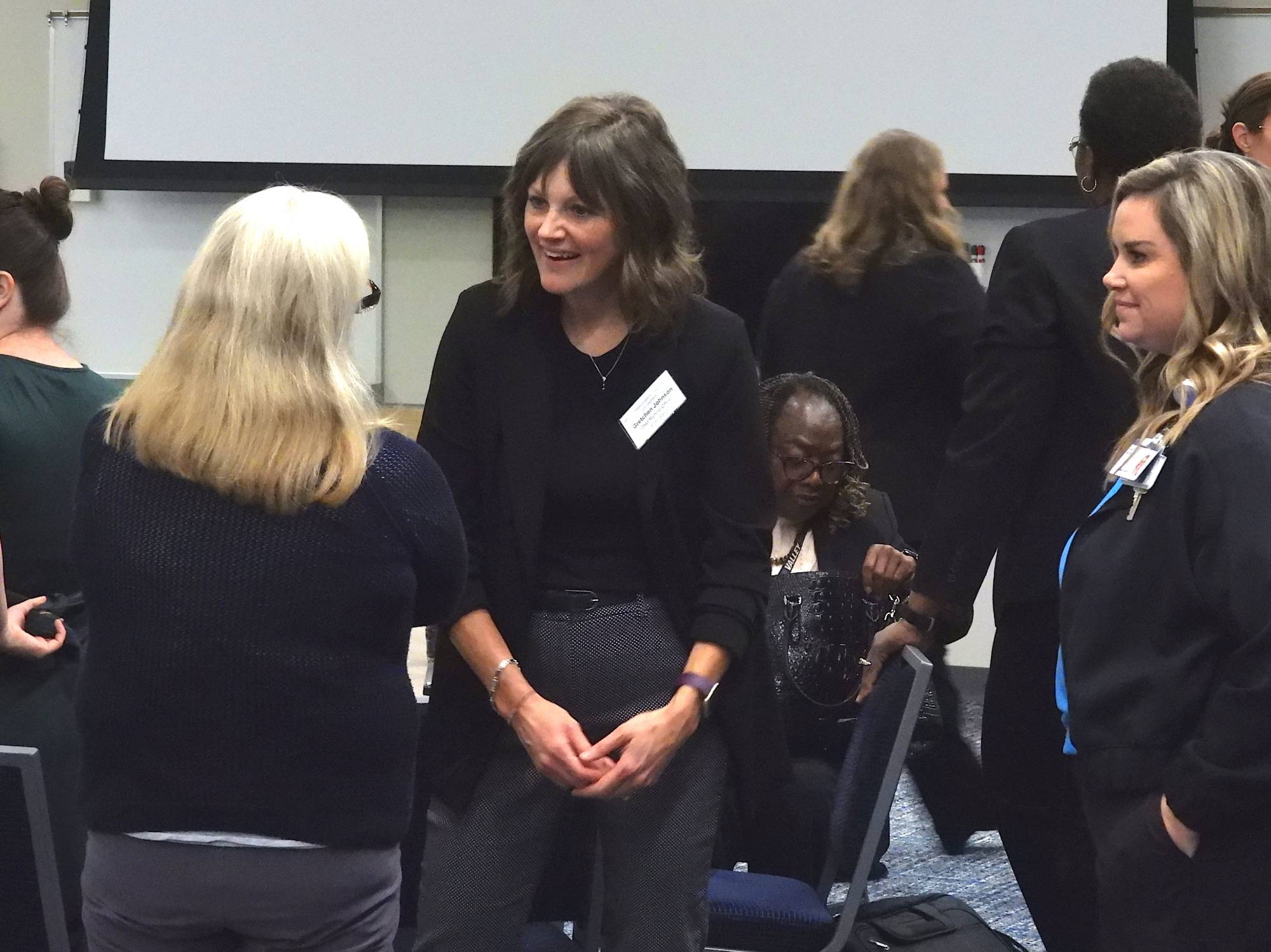 A Collaborate Member talks with a presenter at the end of their presentation.